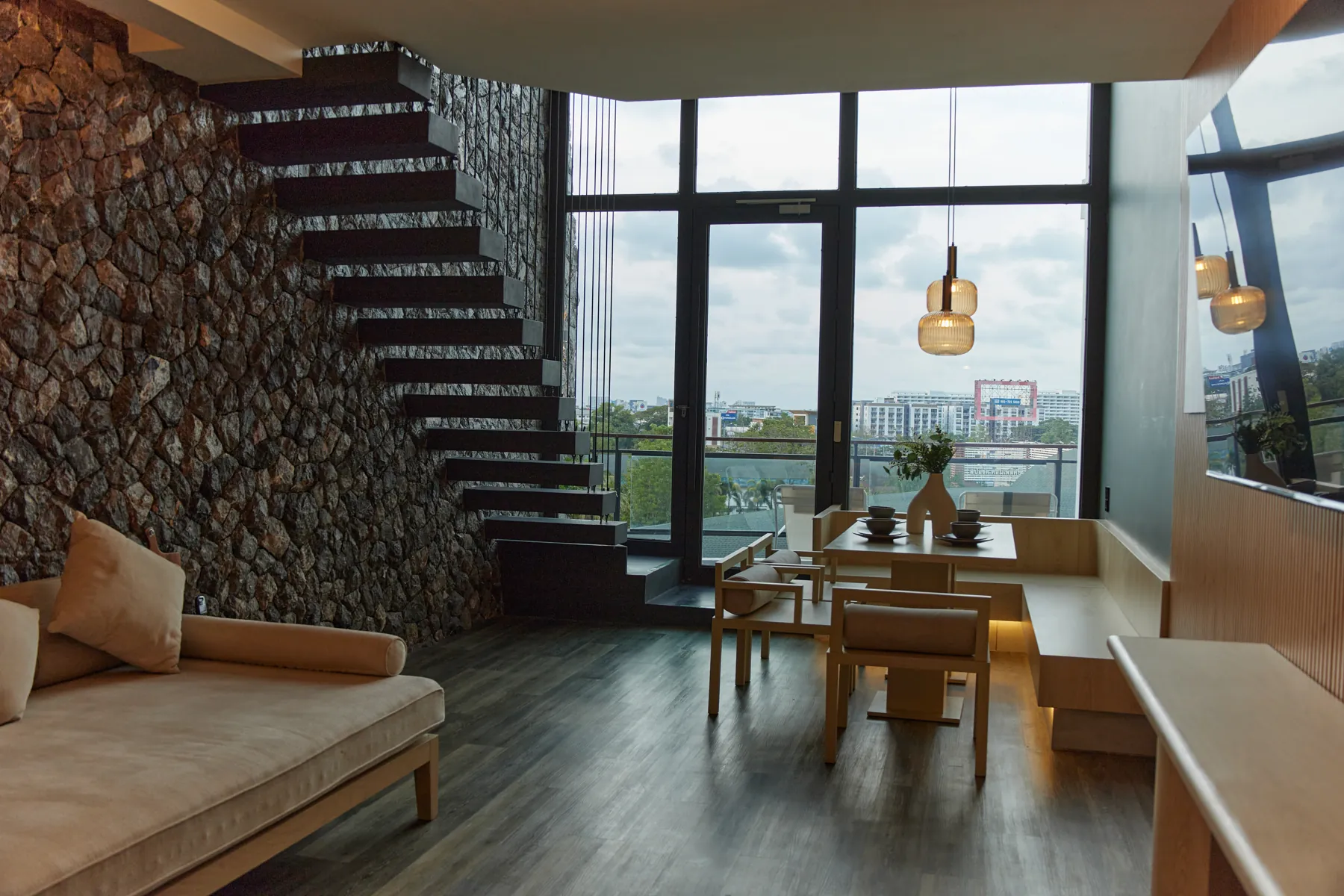 Duplex Suite living area with a stone staircase and floor-to-ceiling windows