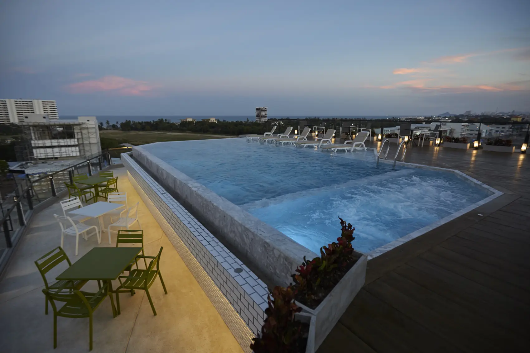 Rooftop pool at sunset and night